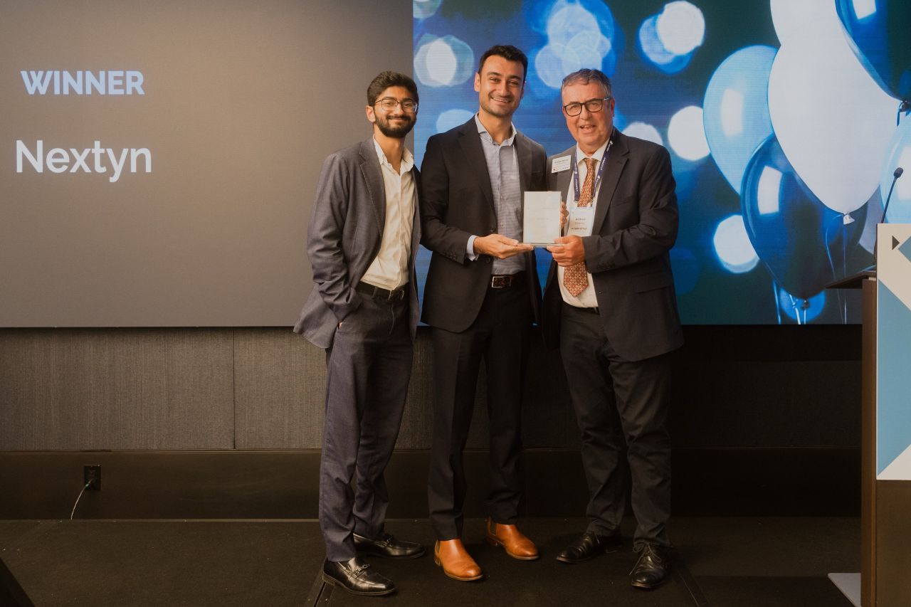 Rasesh Seth and Sid Muralidhar of Nextyn receiving the award on stage in New York