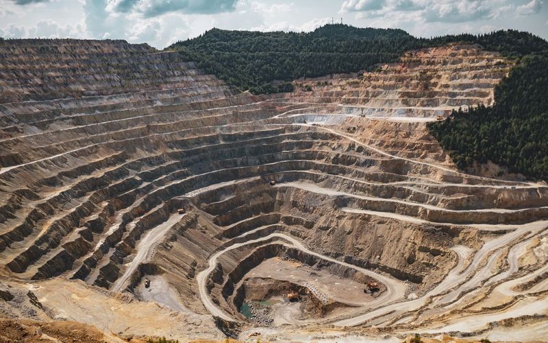 Field immersions case study: aerial view of a large open-pit mine with terraced excavation