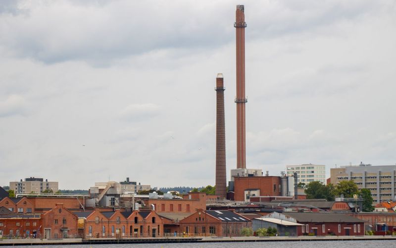 Expert calls case study: industrial chimneys and buildings beside a river
