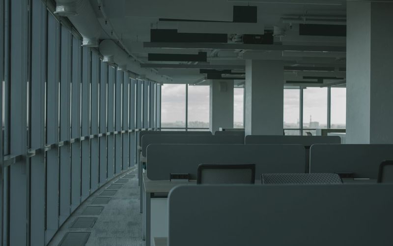 AI moderated calls case study: open-plan office floor with rows of desks and large windows