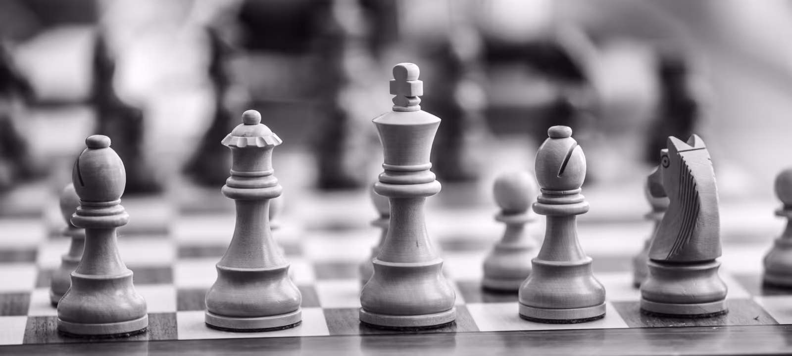 A chess board mid-game photographed low across the pieces
