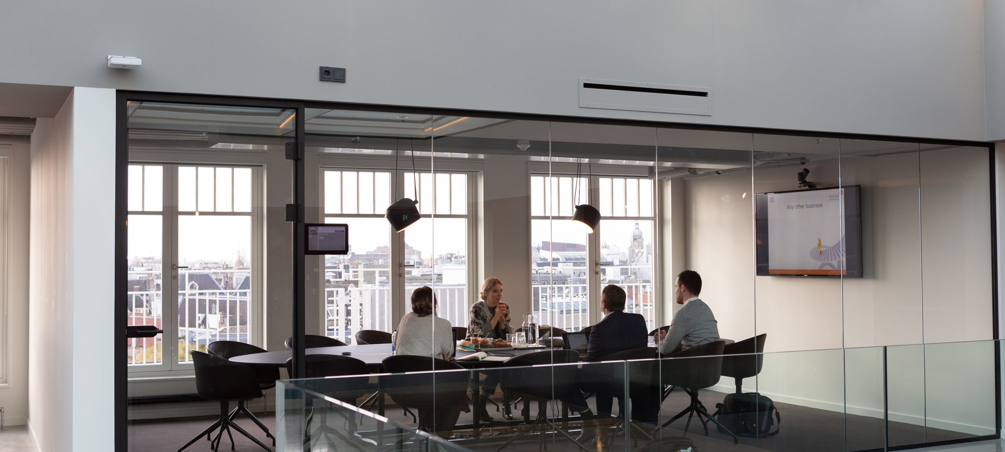 A team meeting in a glass walled office