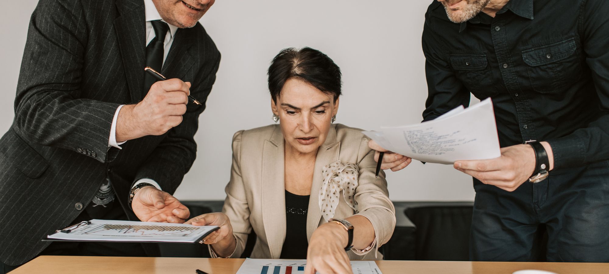 A deal team reviewing documents in a meeting