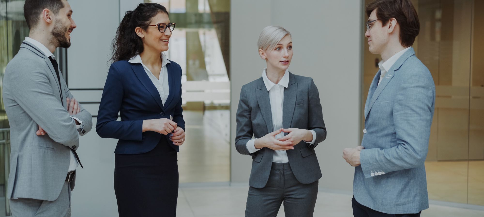 Business professionals talking in a corporate lobby