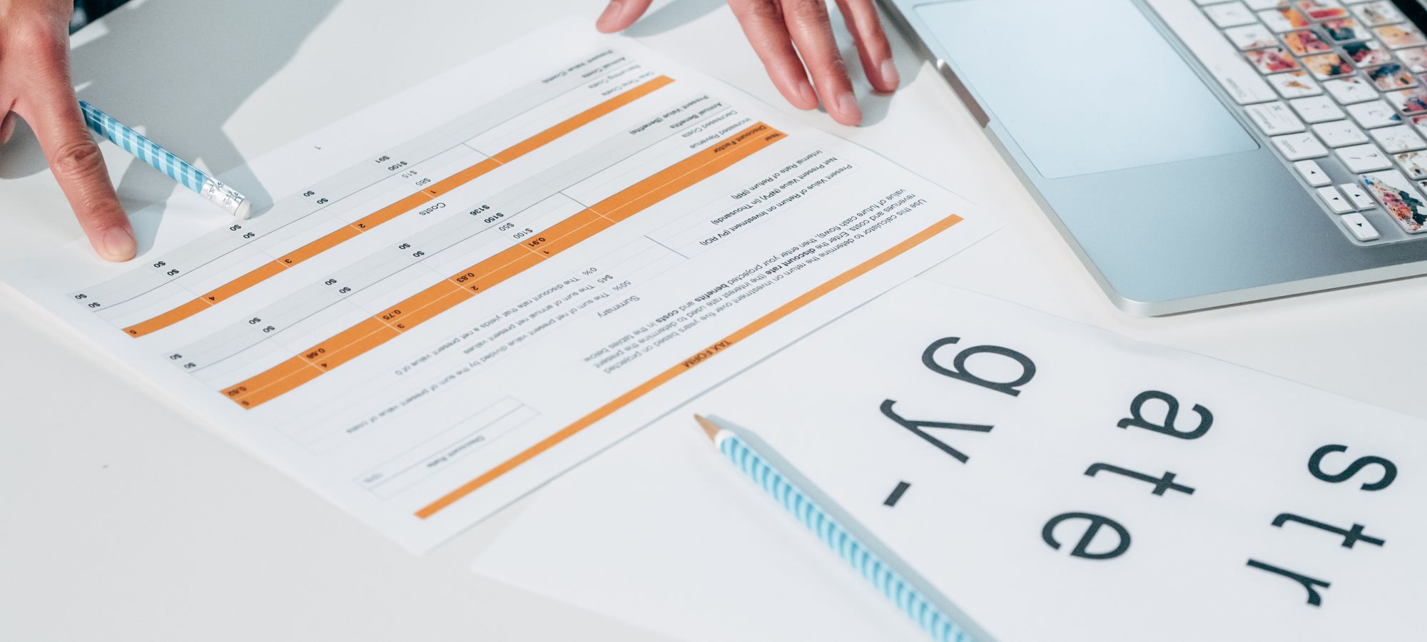 Two people comparing documents on a desk