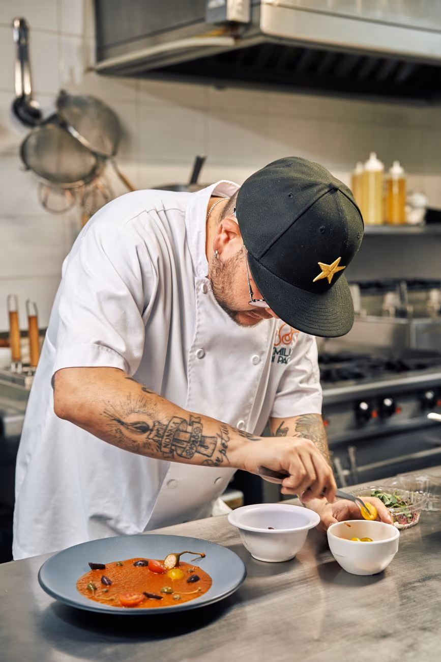 A chef plating at the pass