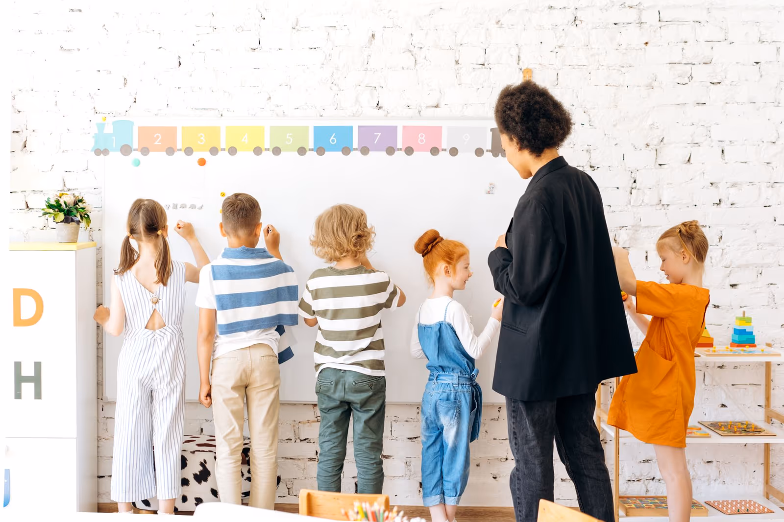 Pupils working at a whiteboard