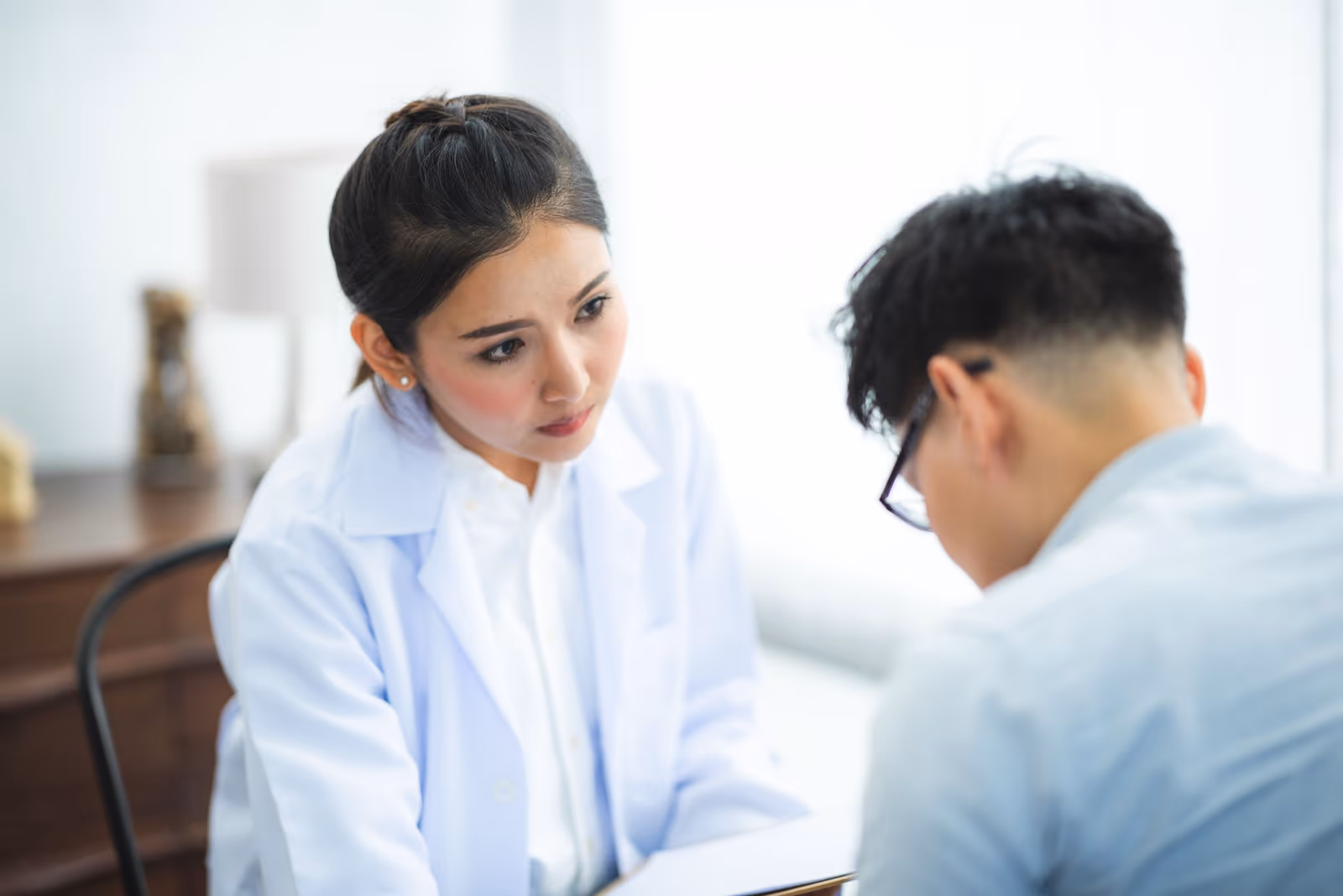 Two clinicians in white coats reviewing results together