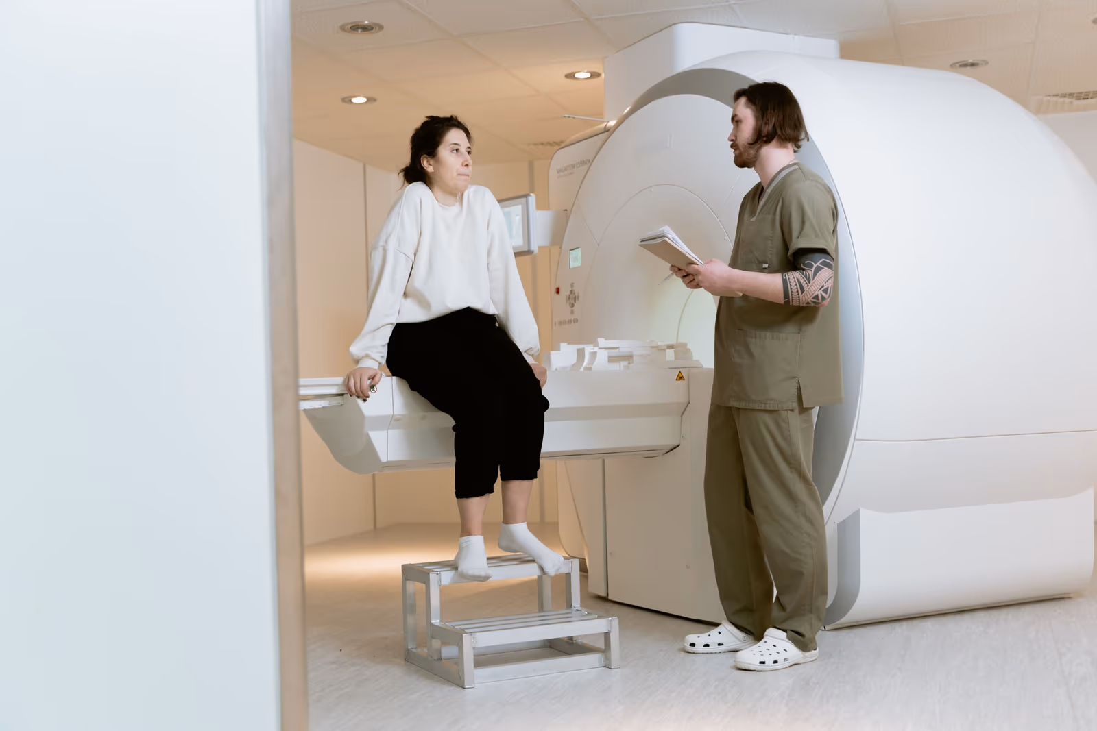 A technician positioning a patient at a medical imaging machine