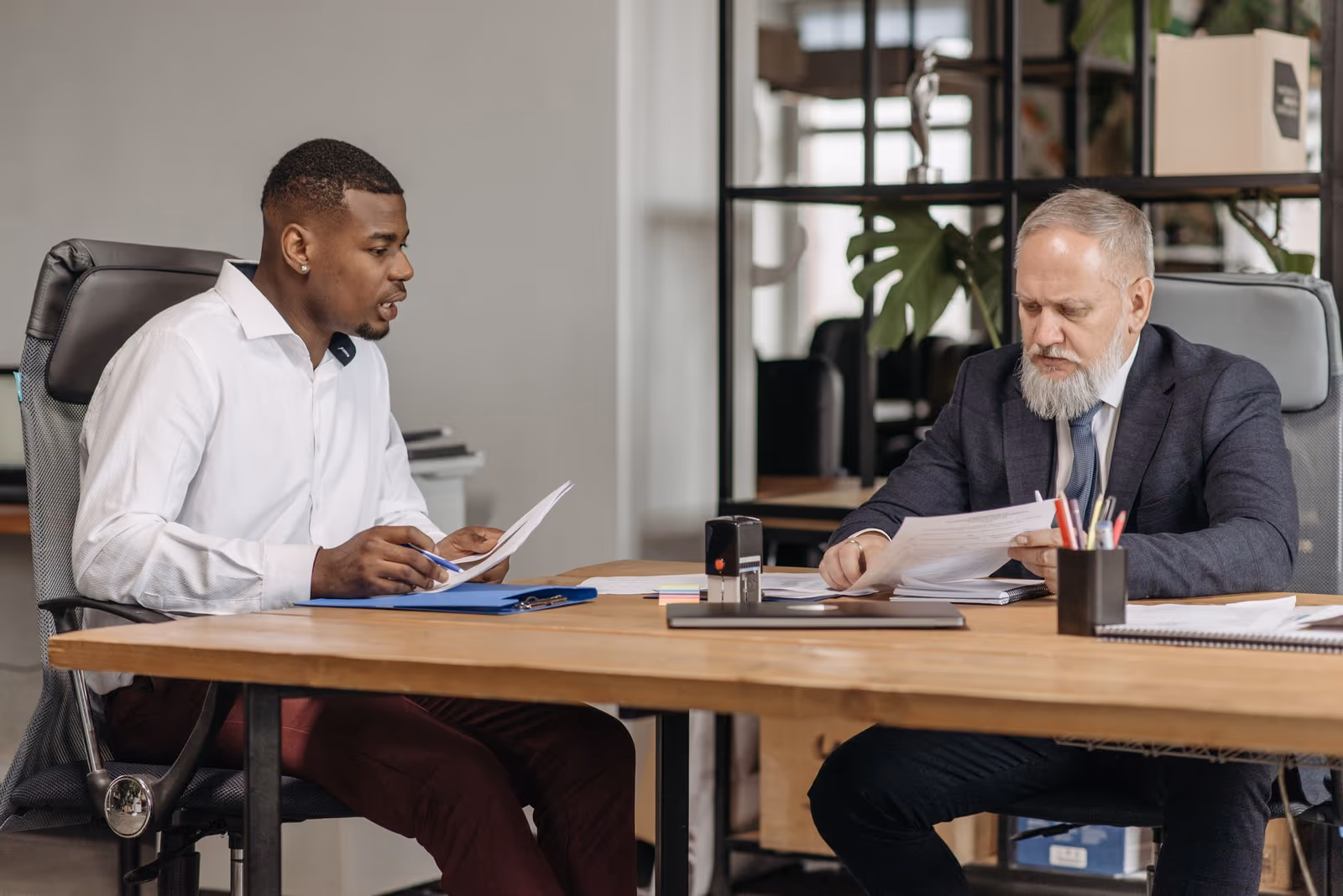 Two investors reviewing documents together