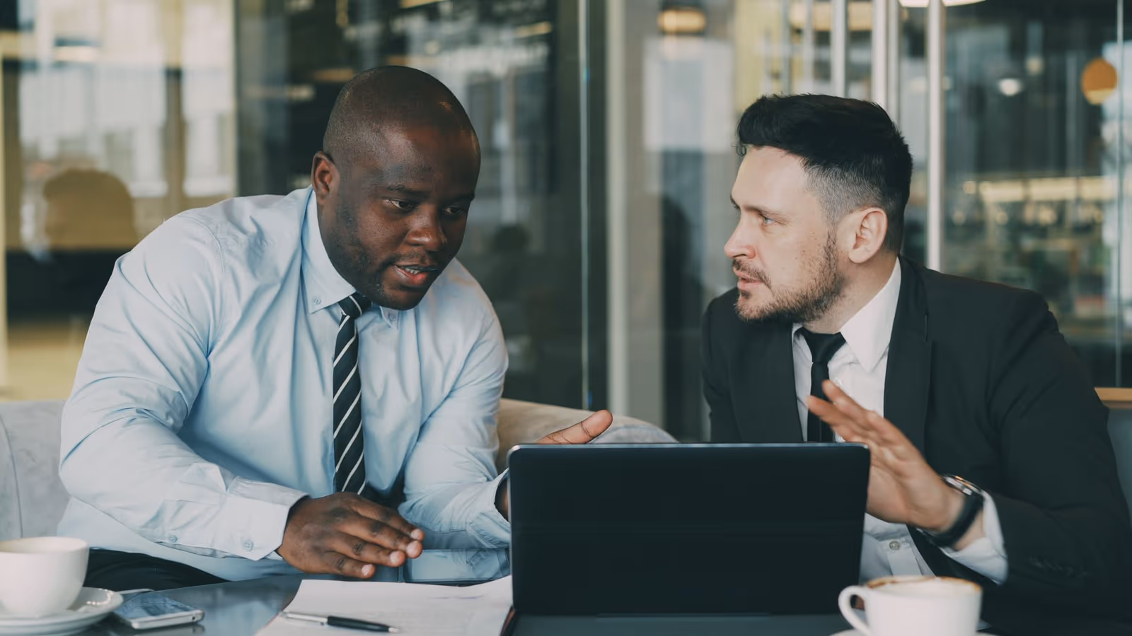 Two executives in a confidential conversation