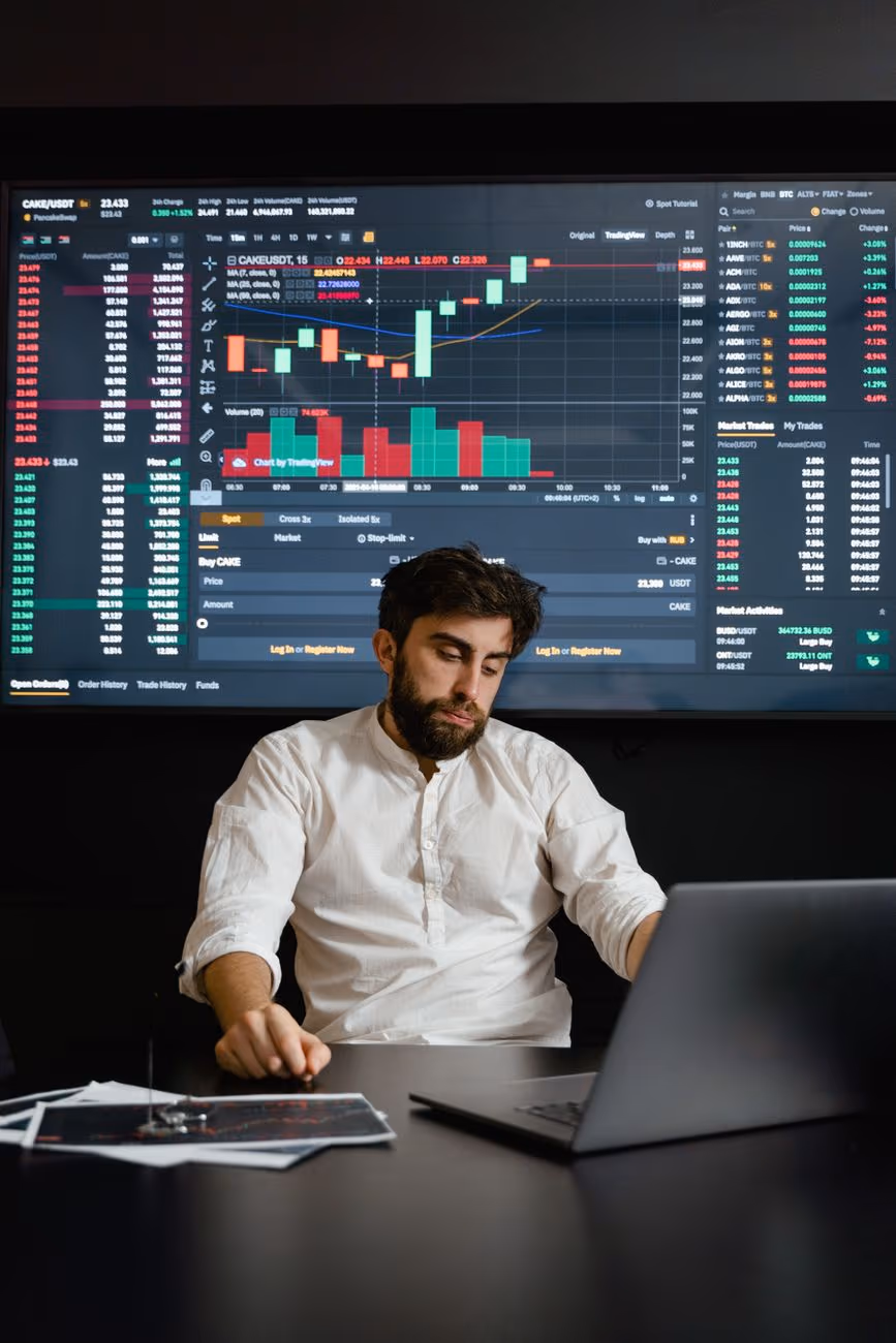 An analyst tracking markets across screens
