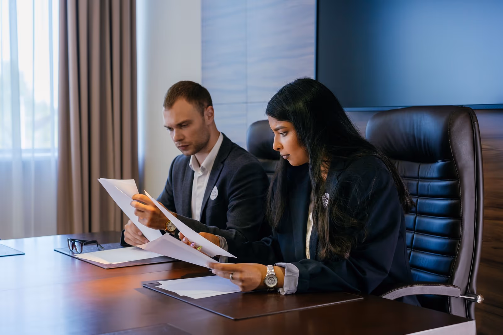 Two investors reviewing documents