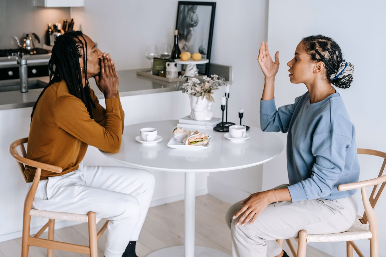 Two practitioners disagreeing across a table