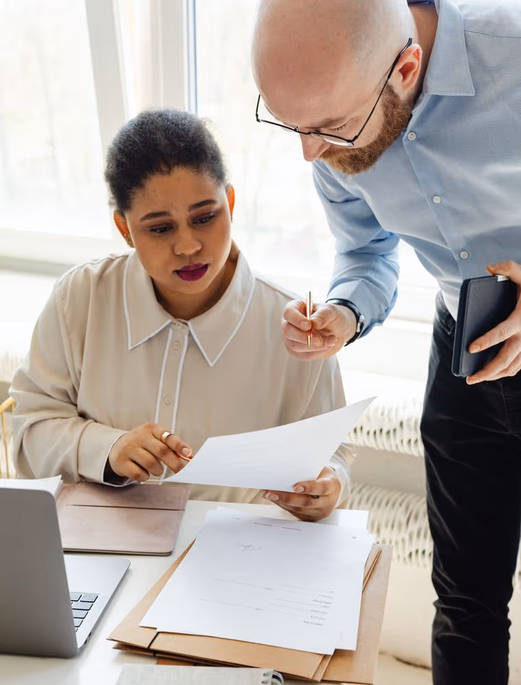 Two investors reviewing a deck in a modern office
