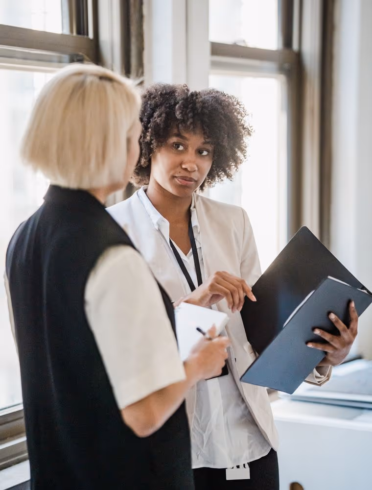 Two corporate executives reviewing a proposal