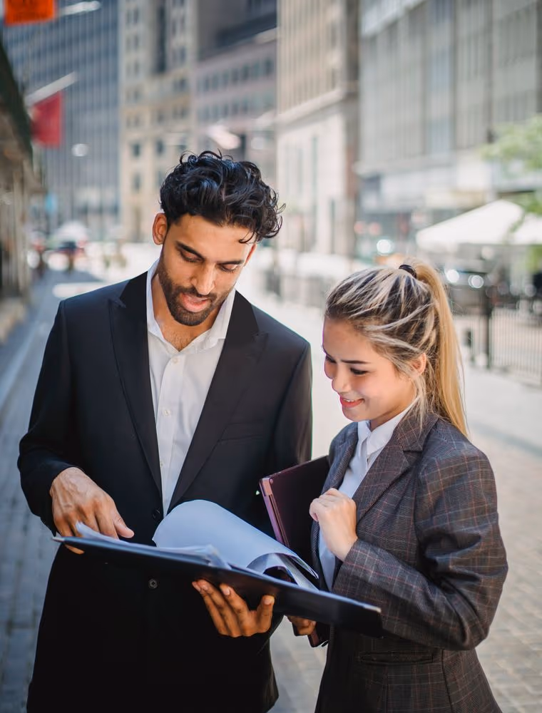 Two bankers reviewing documents in an office