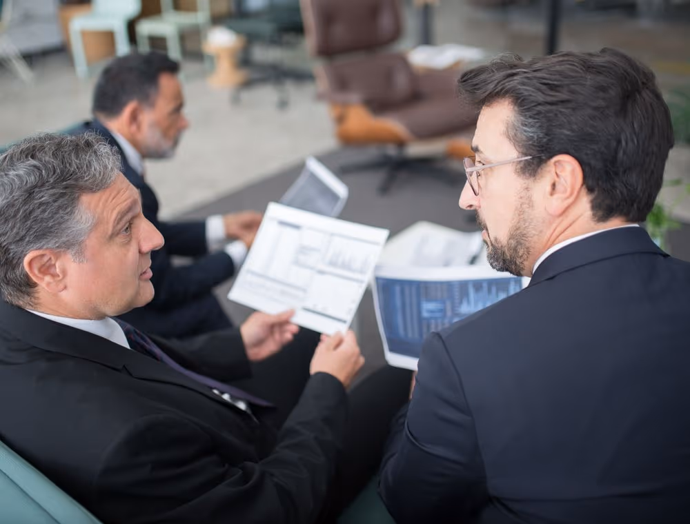Two colleagues comparing notes on a decision