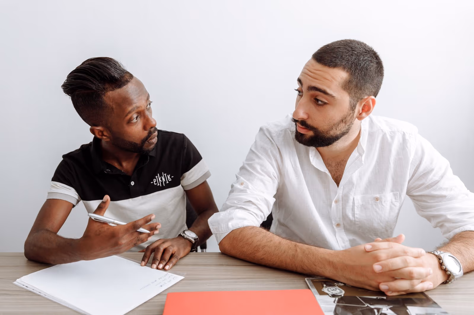 Two colleagues comparing notes during a diligence