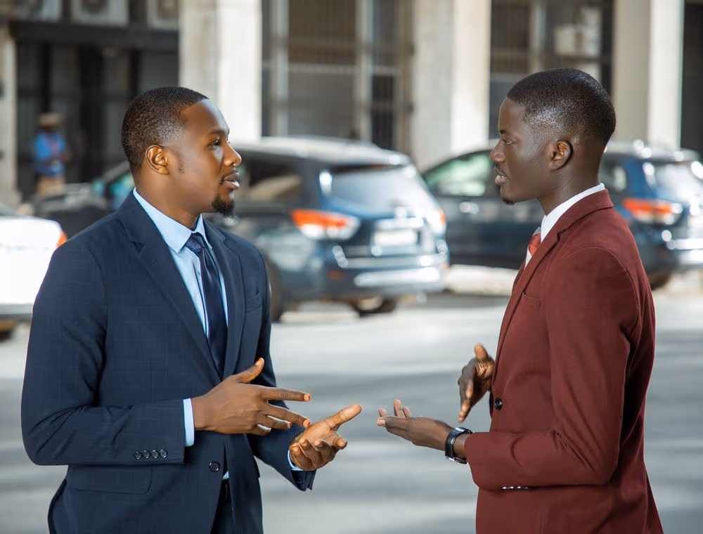 Two colleagues comparing notes on a decision