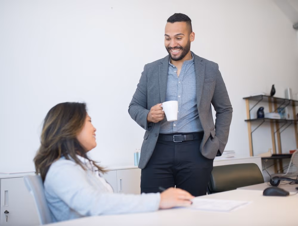 Two colleagues comparing notes on a decision