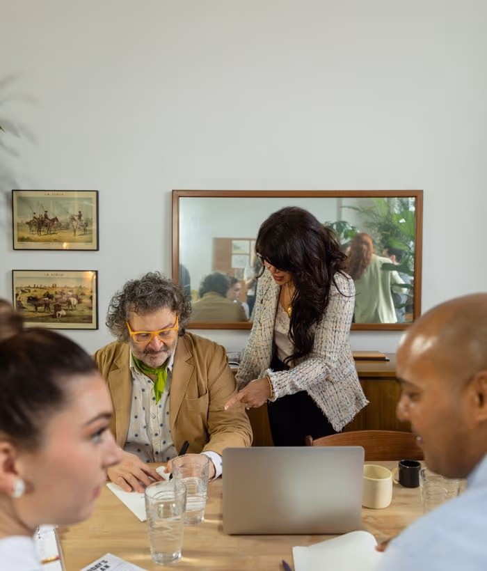 A corporate team meeting around a table