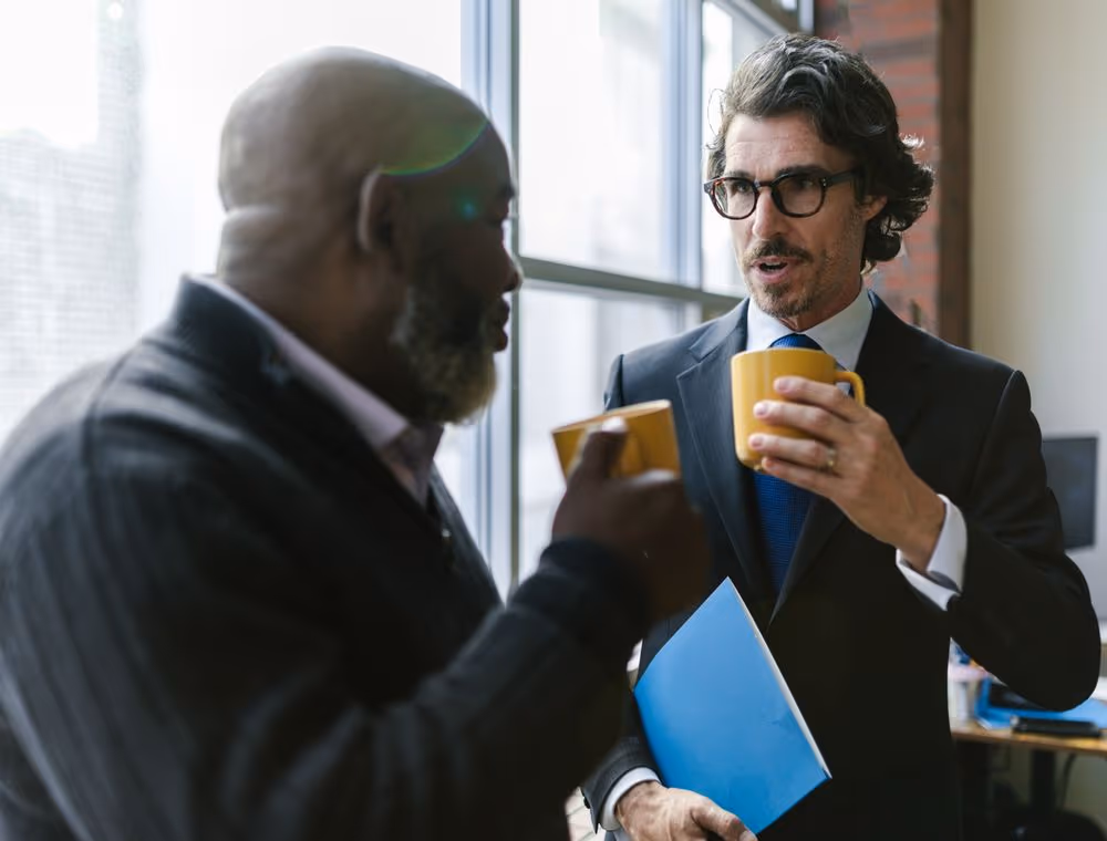 Two colleagues comparing notes on a decision